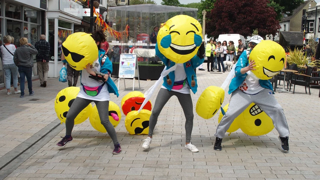 Street performers in emoji costumes