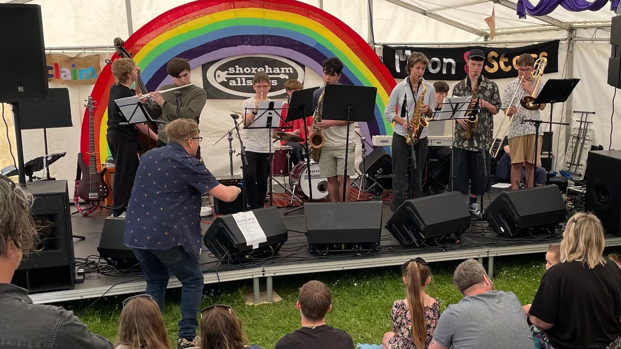 Jazz band performance with rainbow backdrop