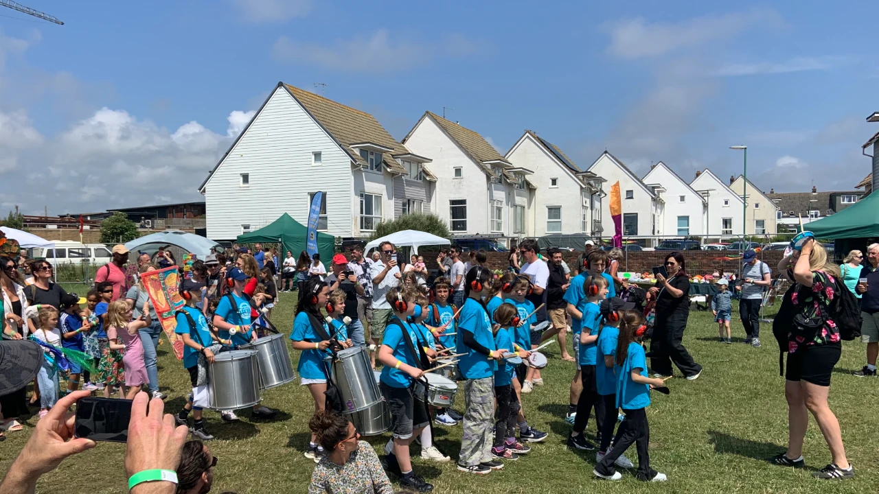 Steel pan band performing at Adur Festival with vibrant community atmosphere